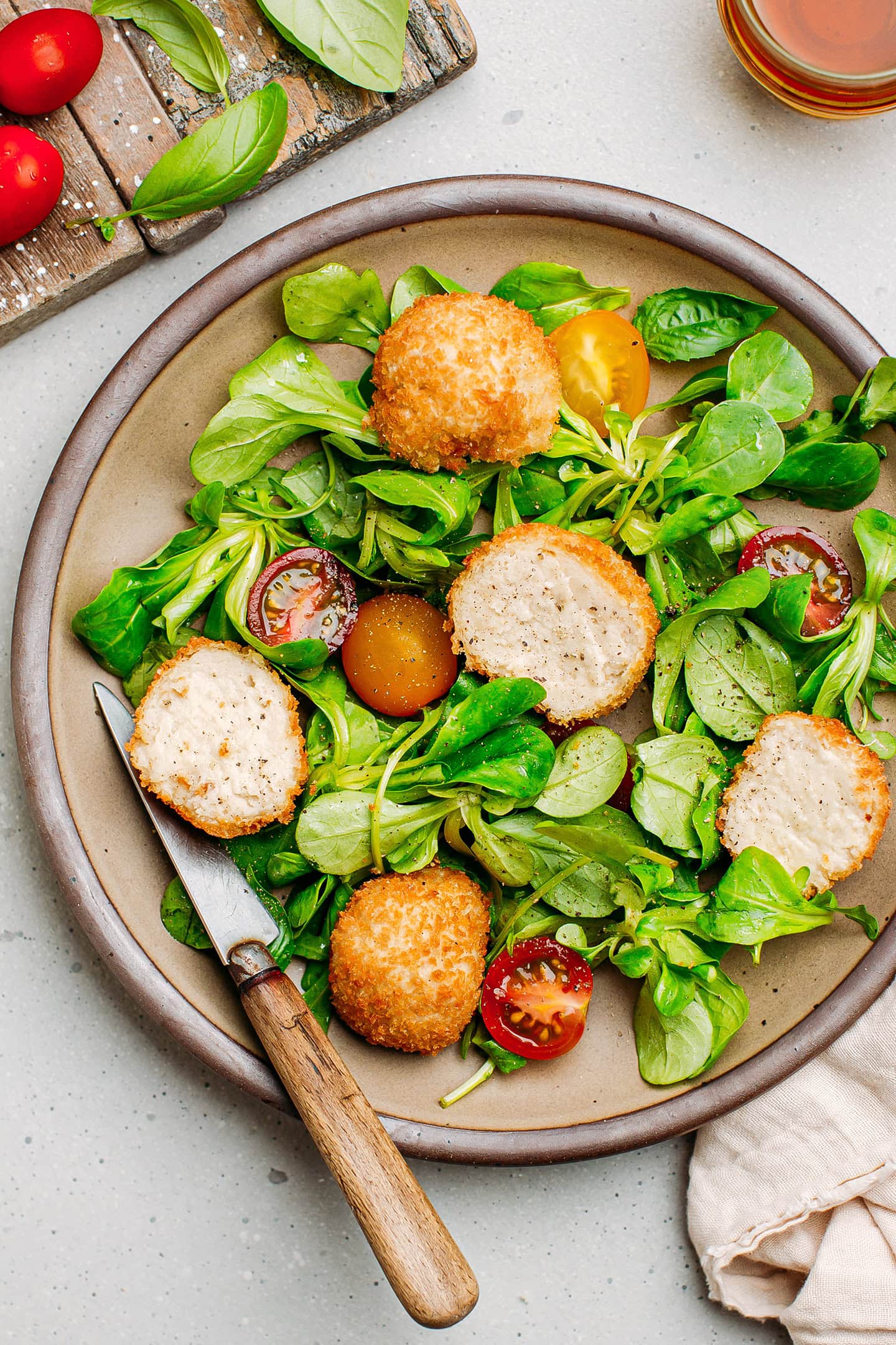 Chevre chaud salad with fried cheese balls, arugula, and tomatoes.