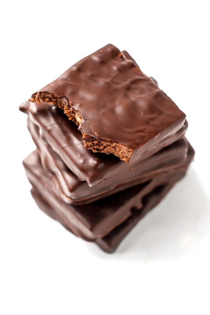 Five chocolate protein bars stacked.