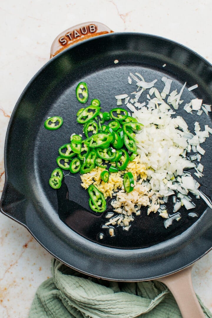 Garlic, onion, ginger, and jalapeno peppers in a skillet.