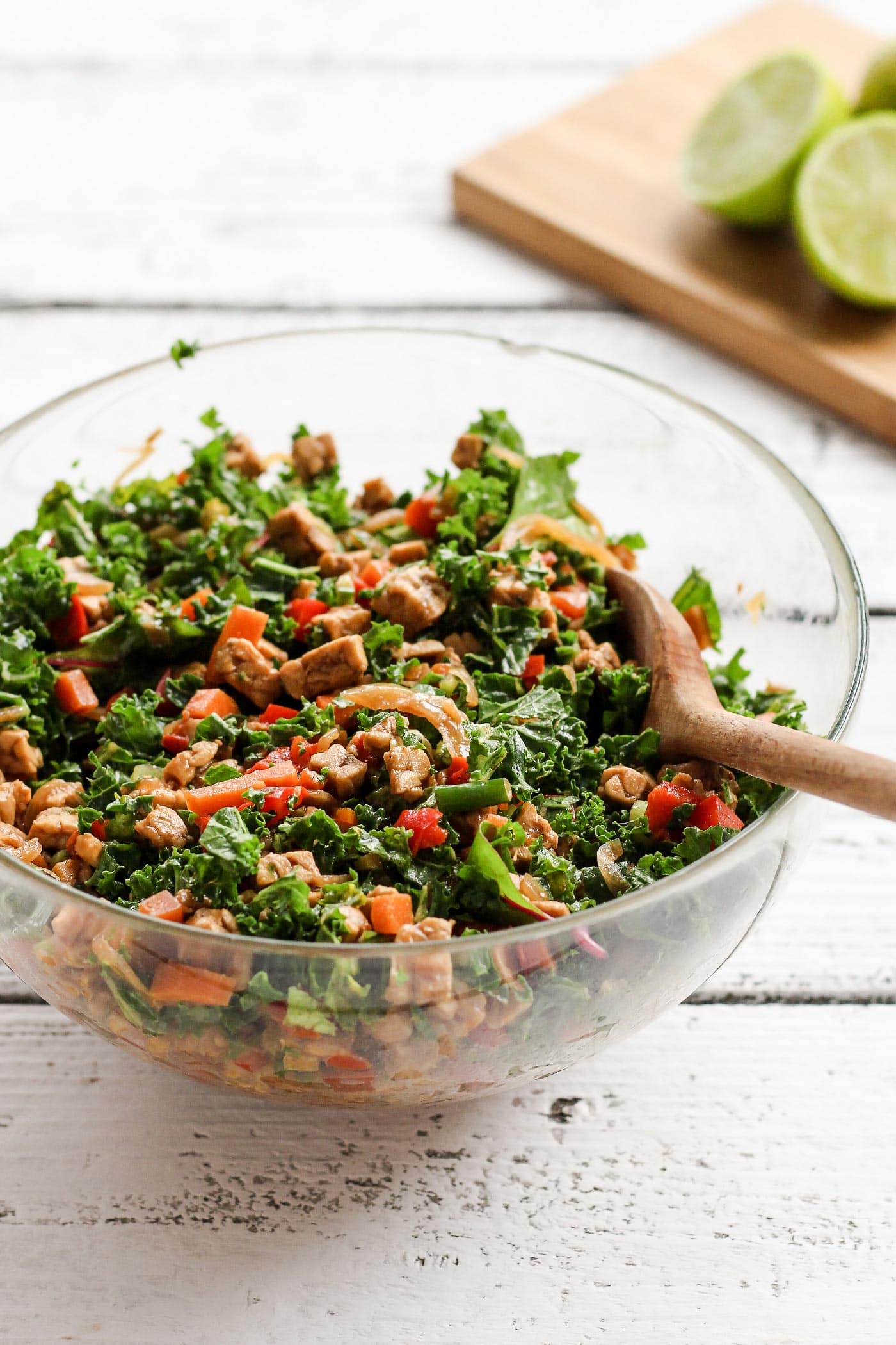 Diced tempeh, chopped kale, green onions, and carrots in a mixing bowl.