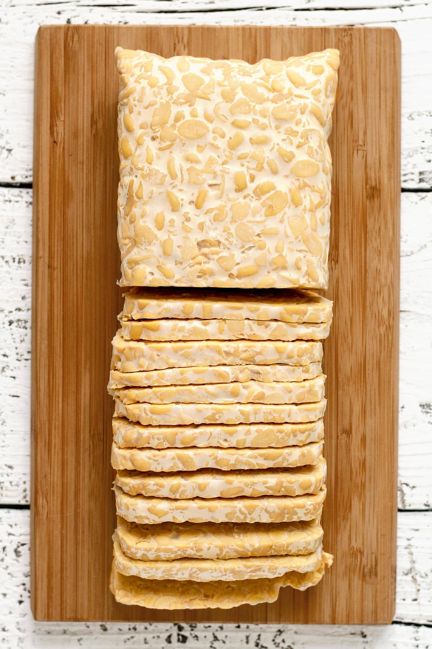 Sliced tempeh on a cutting board.