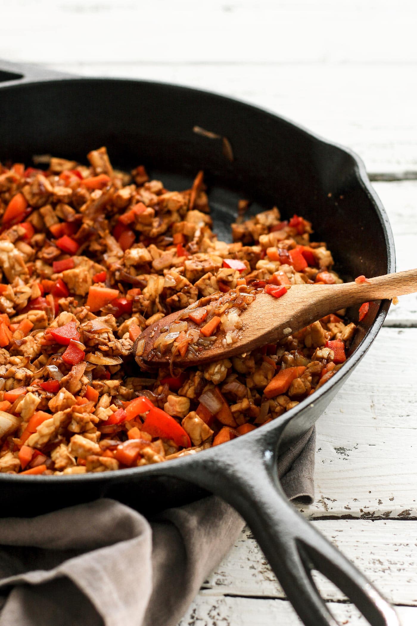 Sautéed carrots and bell peppers in a skillet.