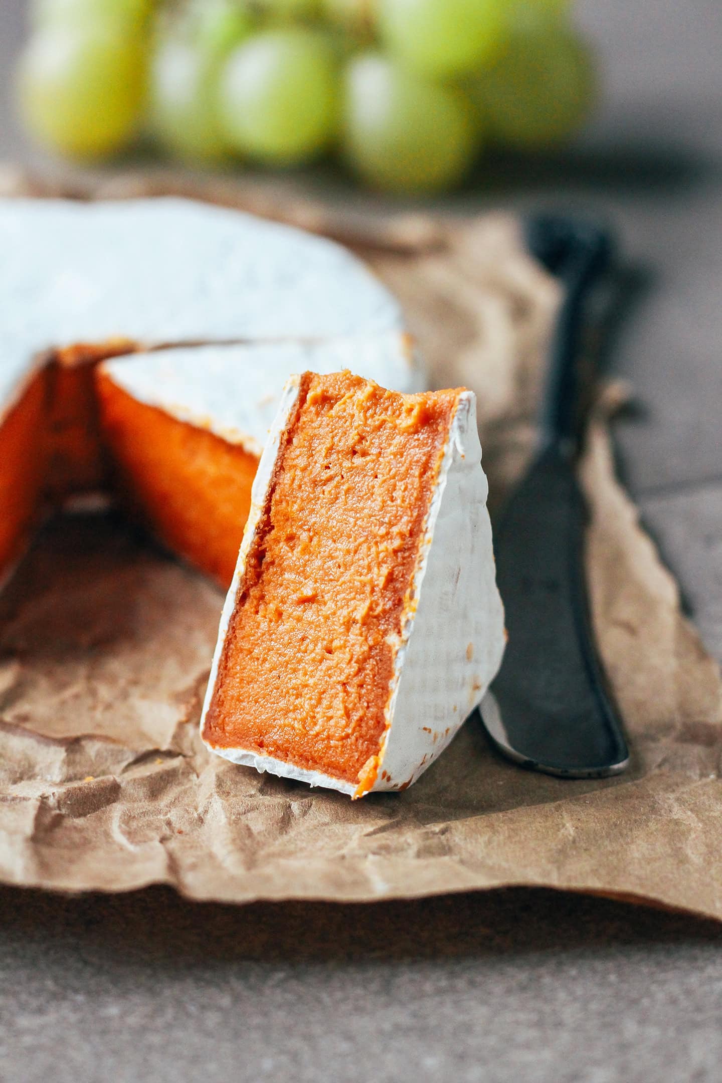 Close-up of a slice of vegan tomato camembert.