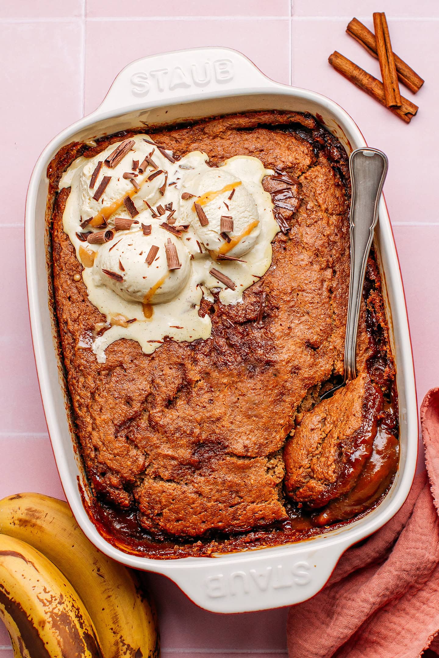 Banana pudding topped with vanilla ice cream and shaved chocolate.