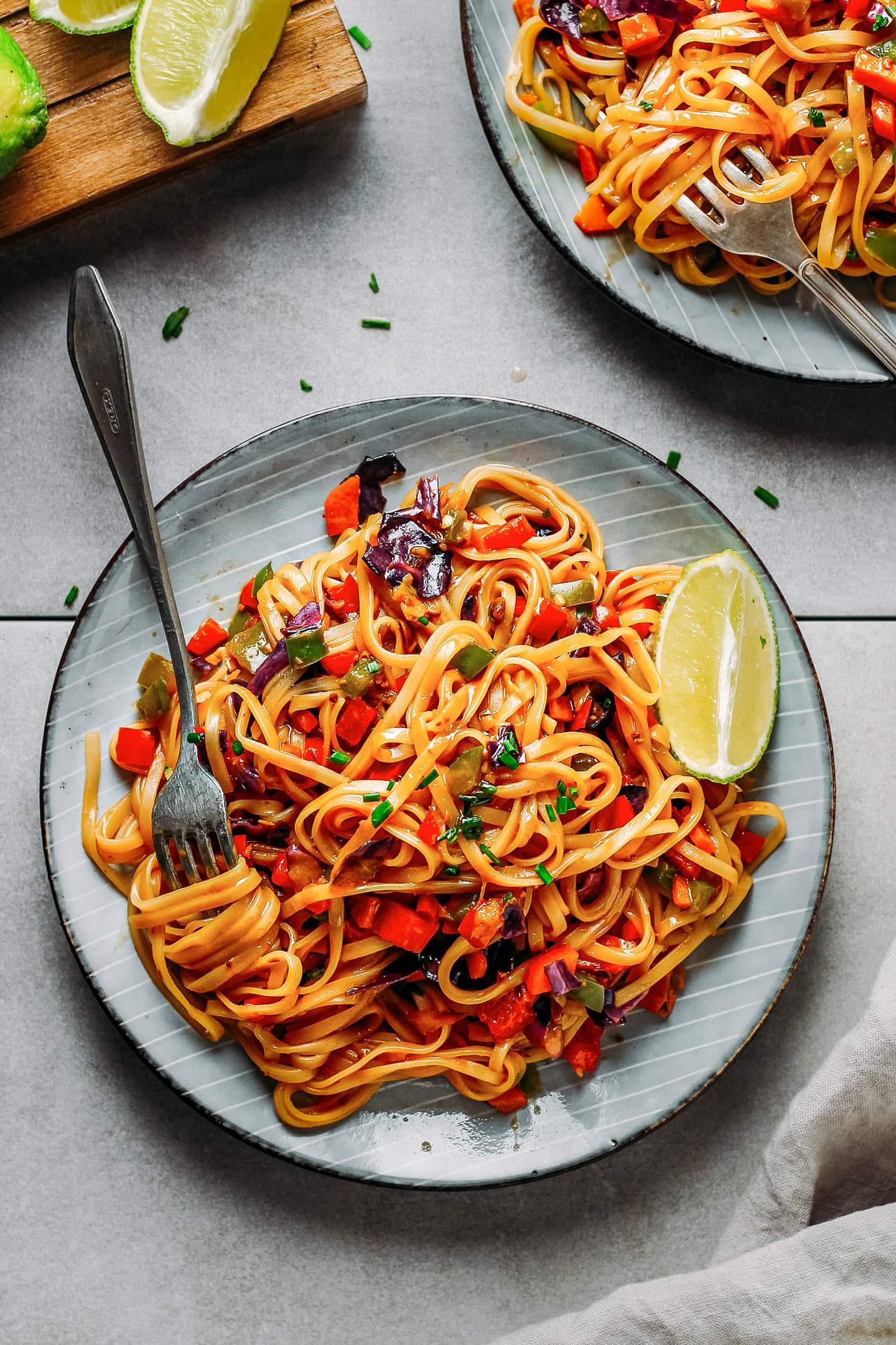 Sweet and spicy noodles with sautéed vegetables on a plate.