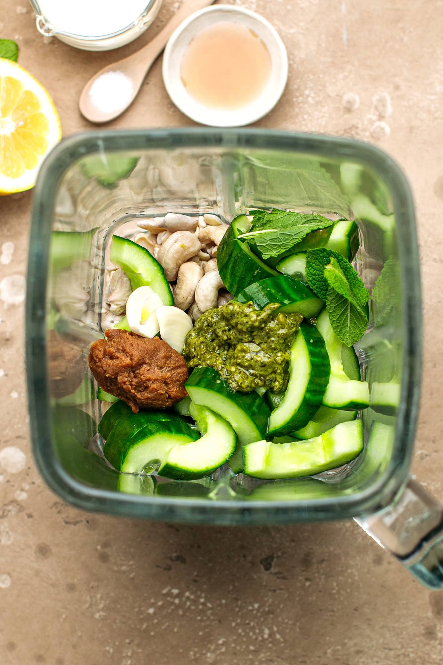 Sliced cucumber, garlic, miso, mint, and cashews in a blender.