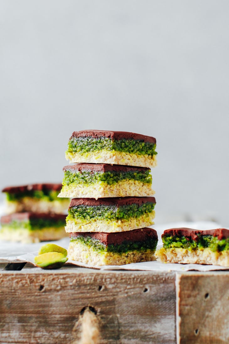 Stacked no-bake chocolate pistachio bars.
