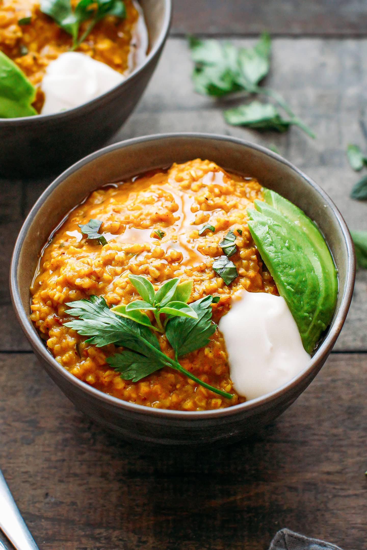 Creamy masala oats topped with avocado and coconut yogurt.