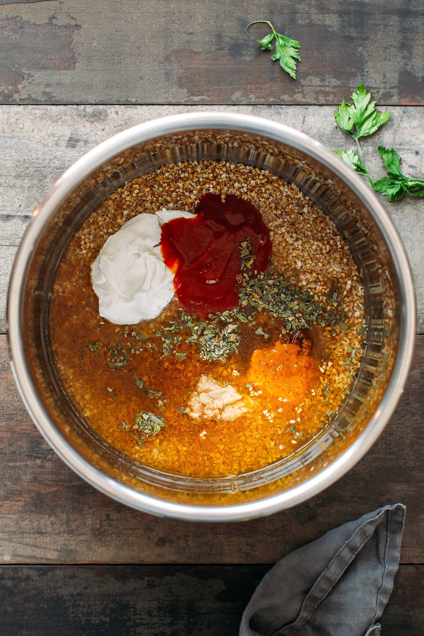 Steel-cut oats, spices, tomato paste, and coconut cream in an Instant Pot.