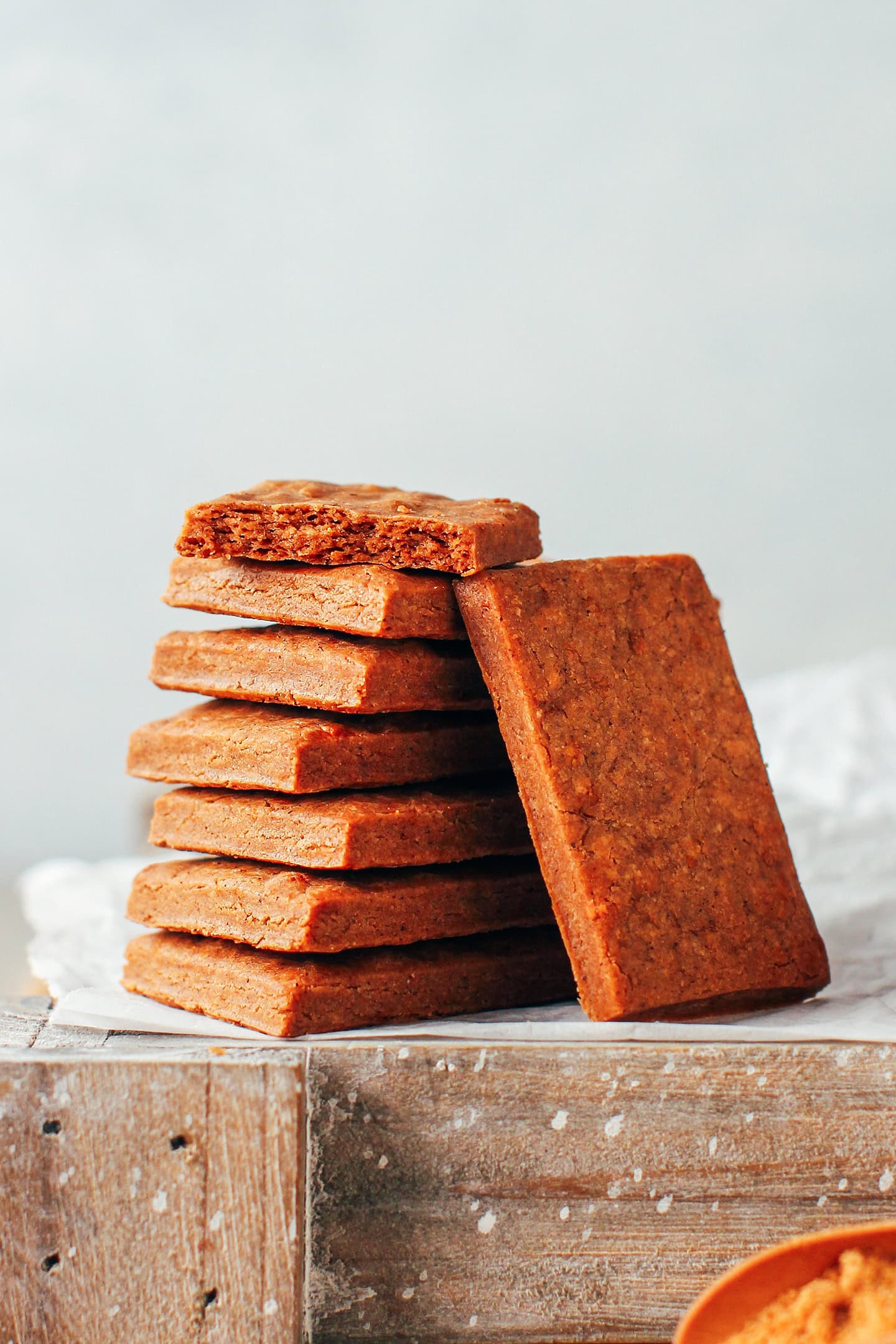 Stacked biscoff cookies on a wooden board.