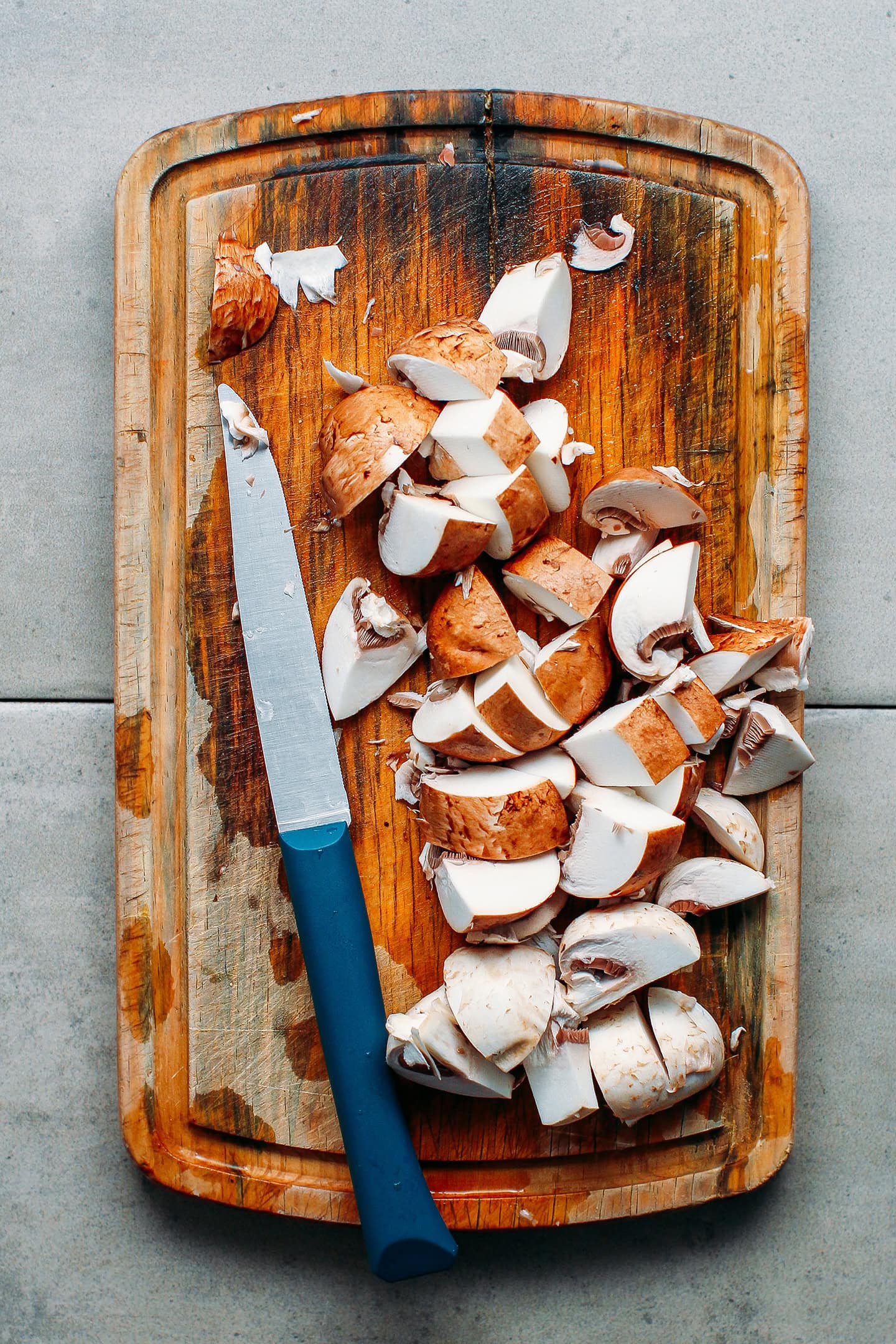 Sliced mushrooms on a cutting board.