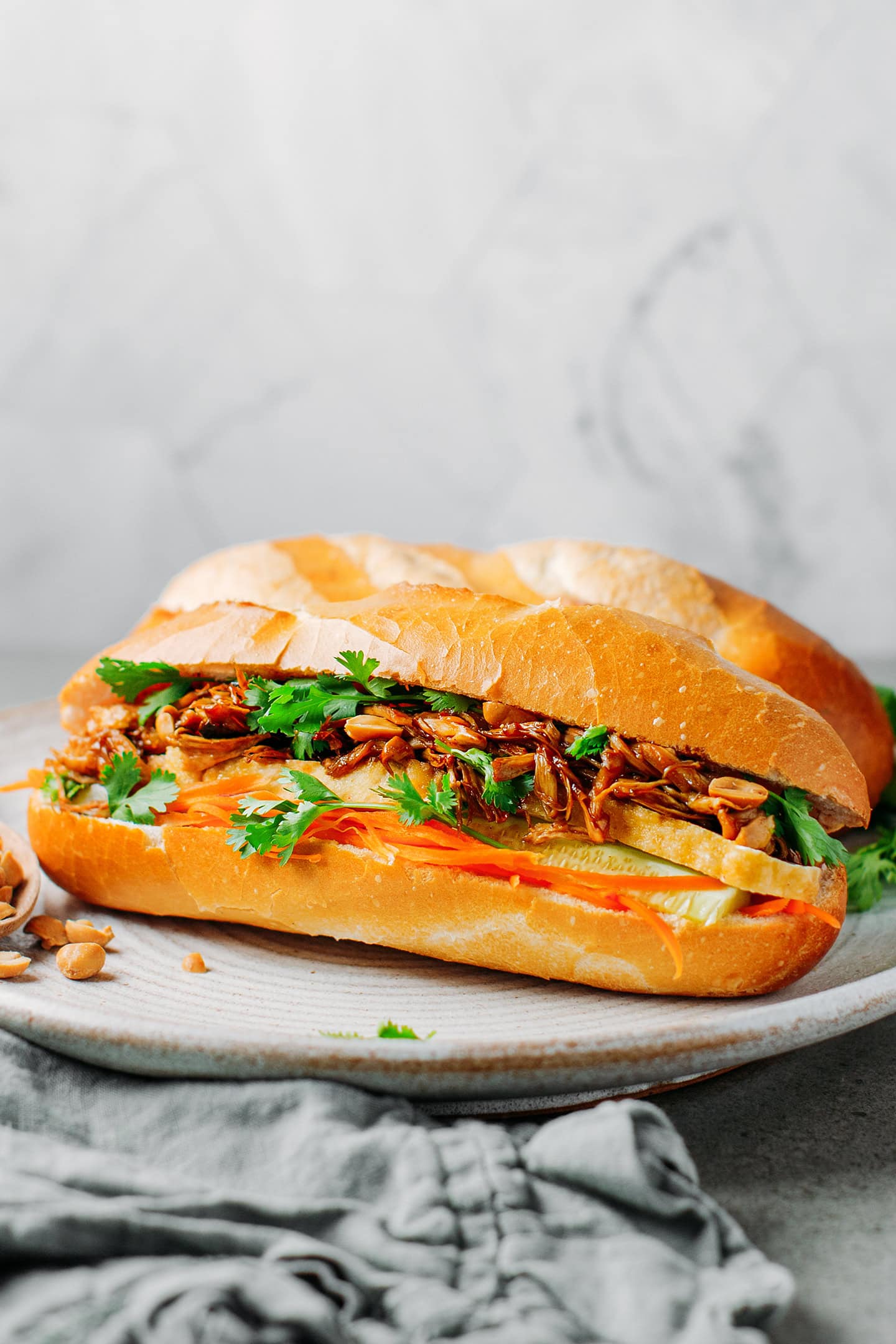 Vegan banh mi filled with pulled mushrooms, cilantro, and cucumber.