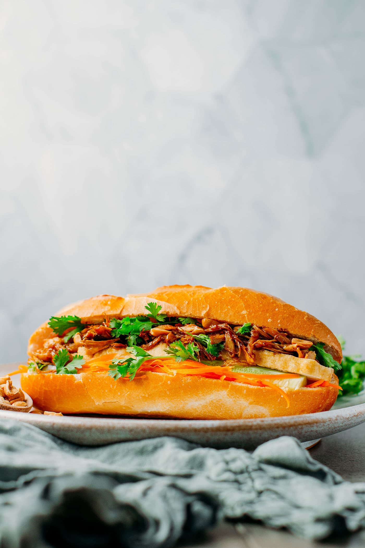 https://fullofplants.com/wp-content/uploads/2020/02/best-vegan-banh-mi-with-pulled-king-oyster-mushrooms-tofu-soy-sauce-pickled-veggies-16.jpg