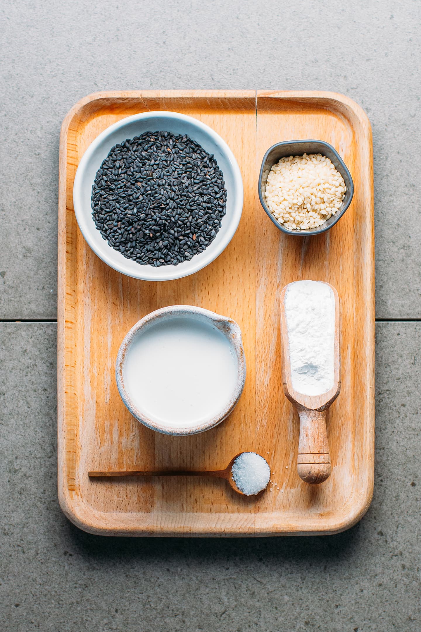 Ingredients like black sesame seeds, coconut milk, sweet rice flour, and sugar.