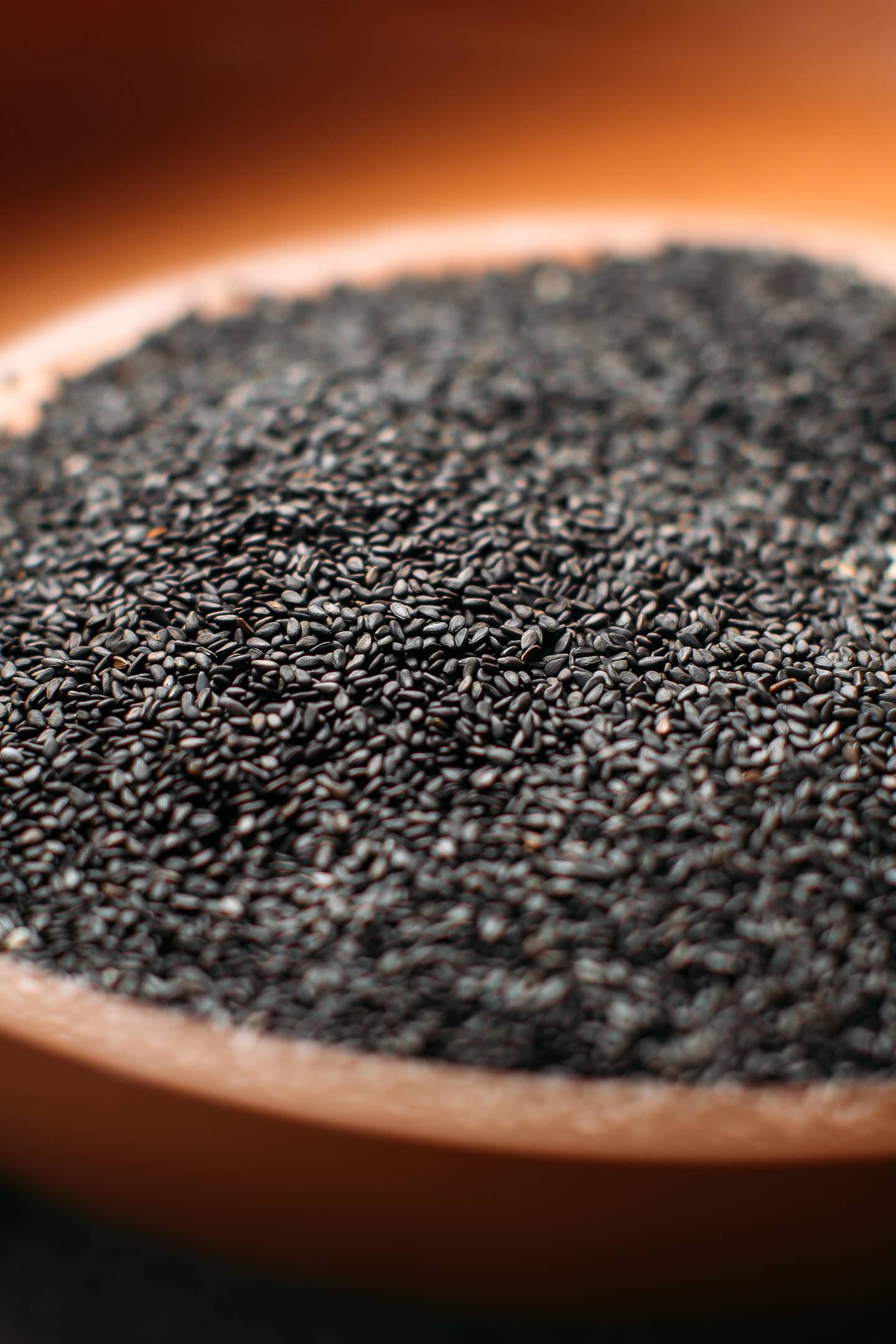 Close up of toasted black sesame seeds in a pan.