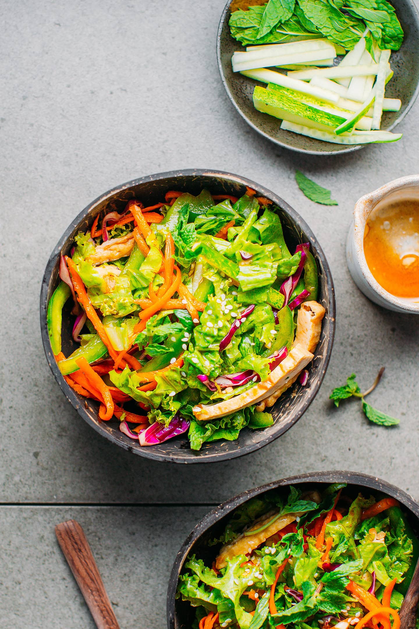 Top view of a coconut bowl filled with vegetable salad.