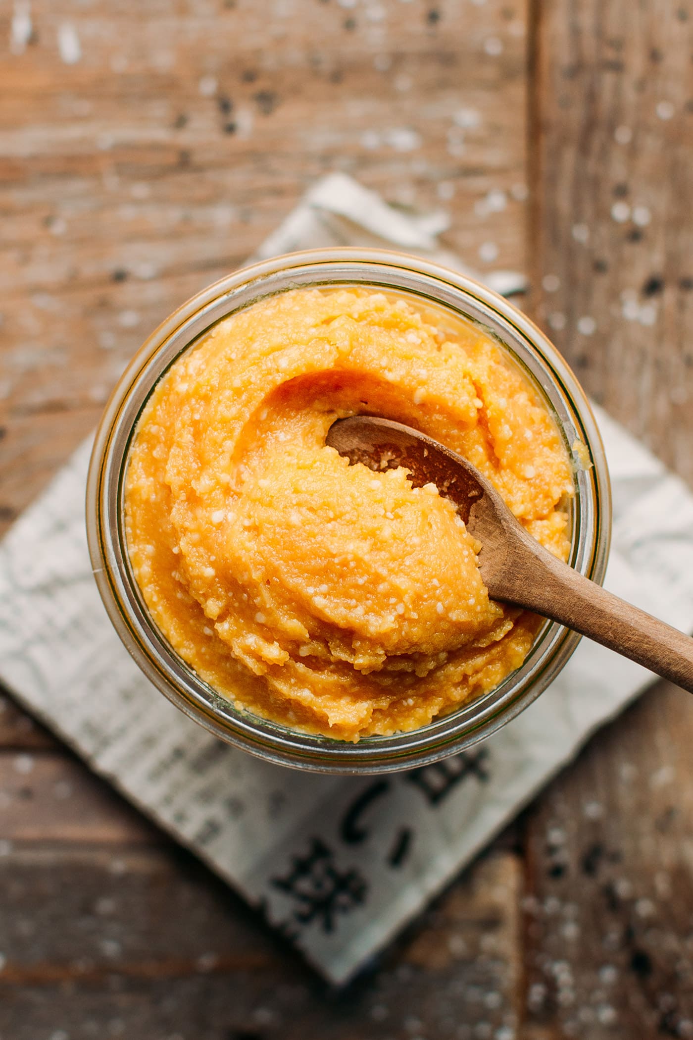 Chickpea miso in a jar with a spoon.