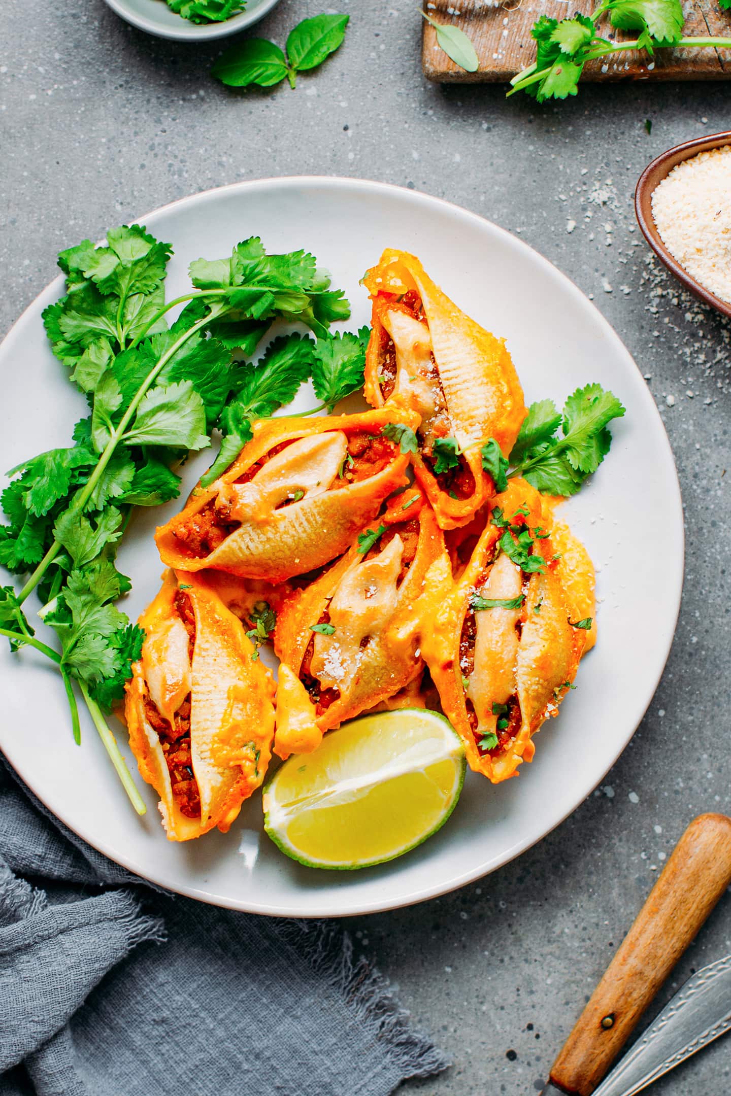 Vegan shells filled with tempeh and buffalo sauce on a plate.