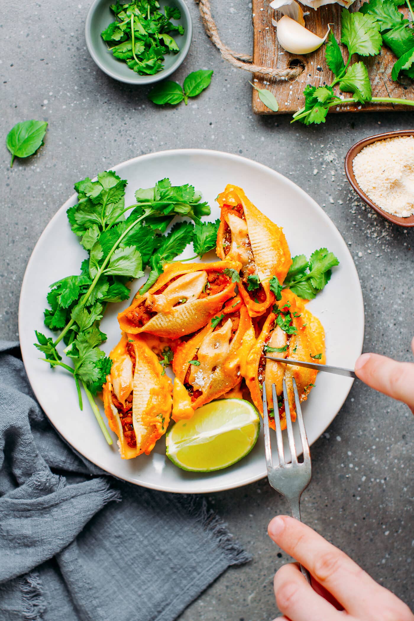 Slicing stuffed shells filled with tempeh and buffalo sauce.