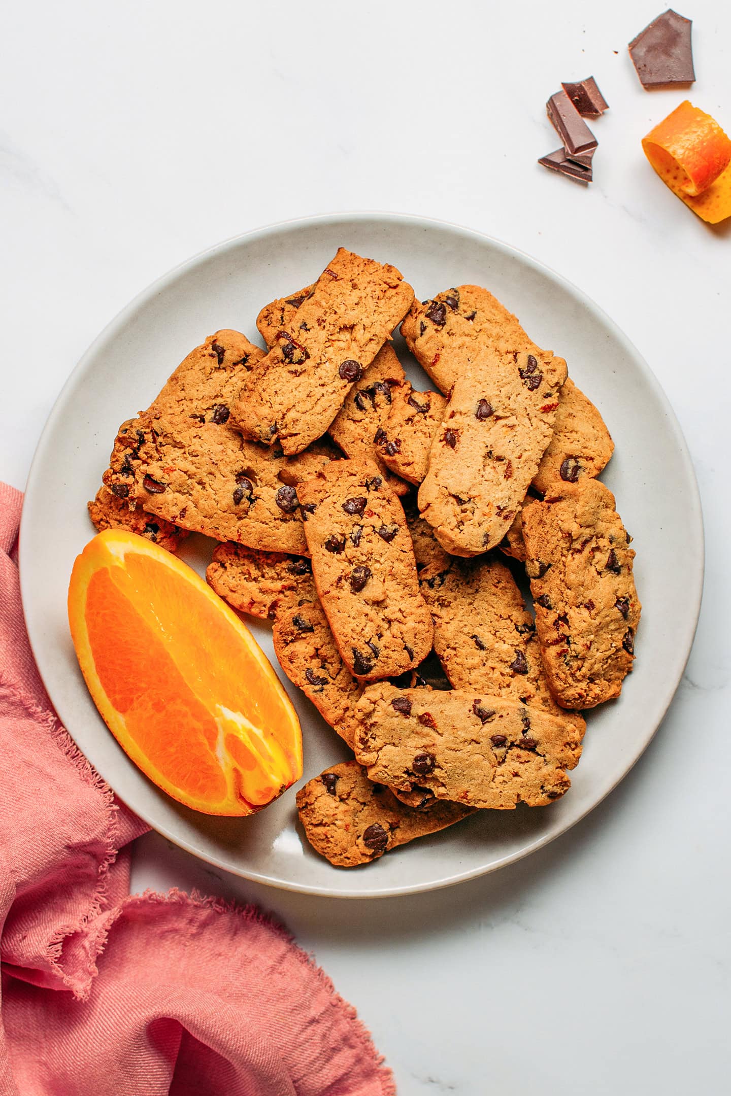 Chocolate chip and orange shortbread cookies on a plate.