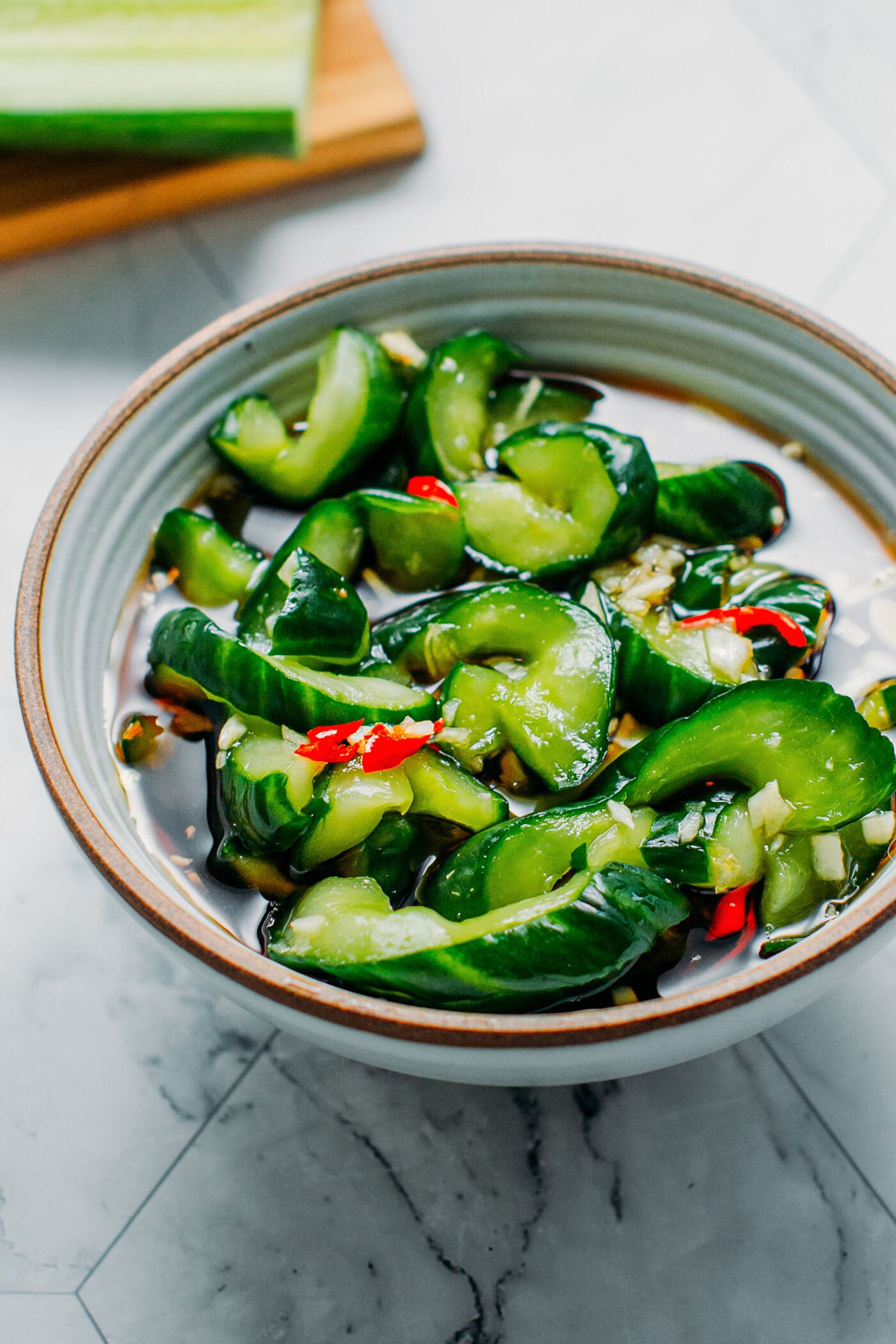 Pickled cucumbers with chilies in a bowl.