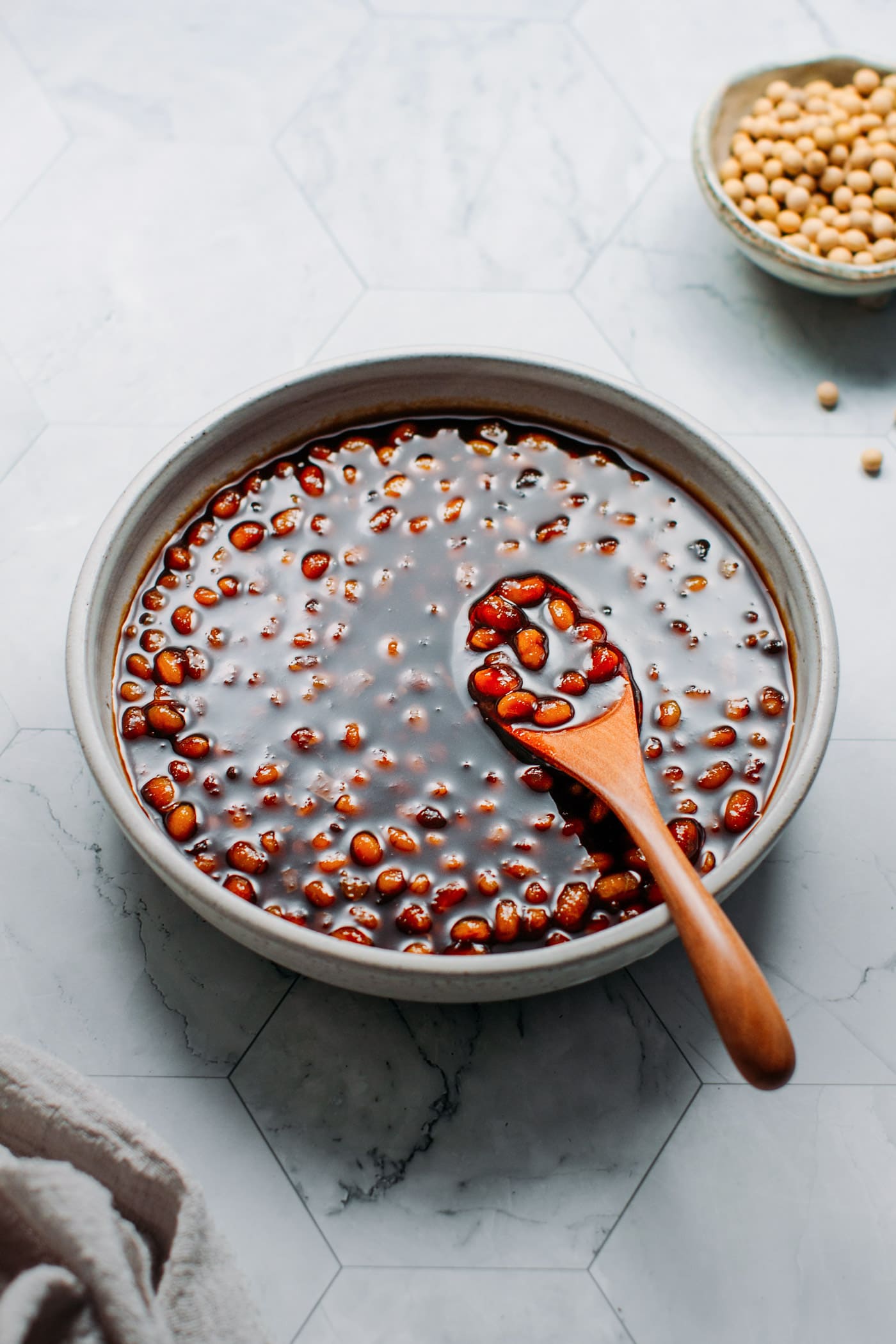 Vietnamese Soybean Sauce in a bowl with a wooden spoon.