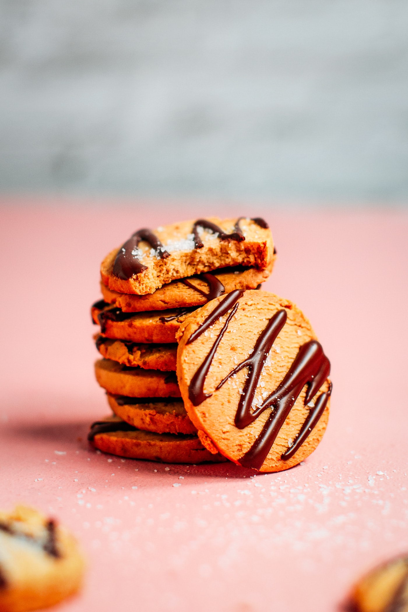 Stack of shortbread cookies with chocolate drizzle and sea salt.