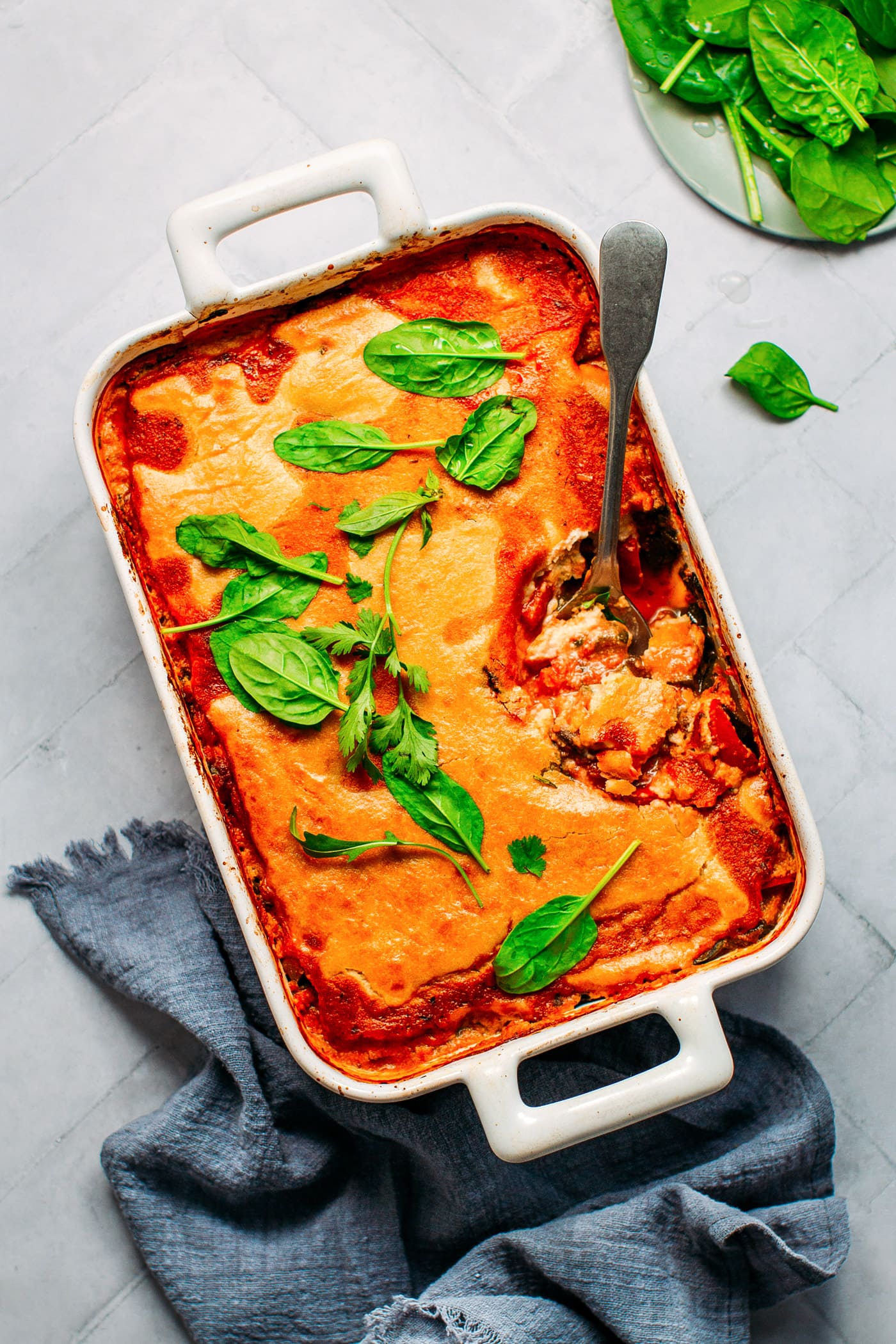 Cheesy vegan vegetable bake with tomato, roasted veggies and cashew cream.