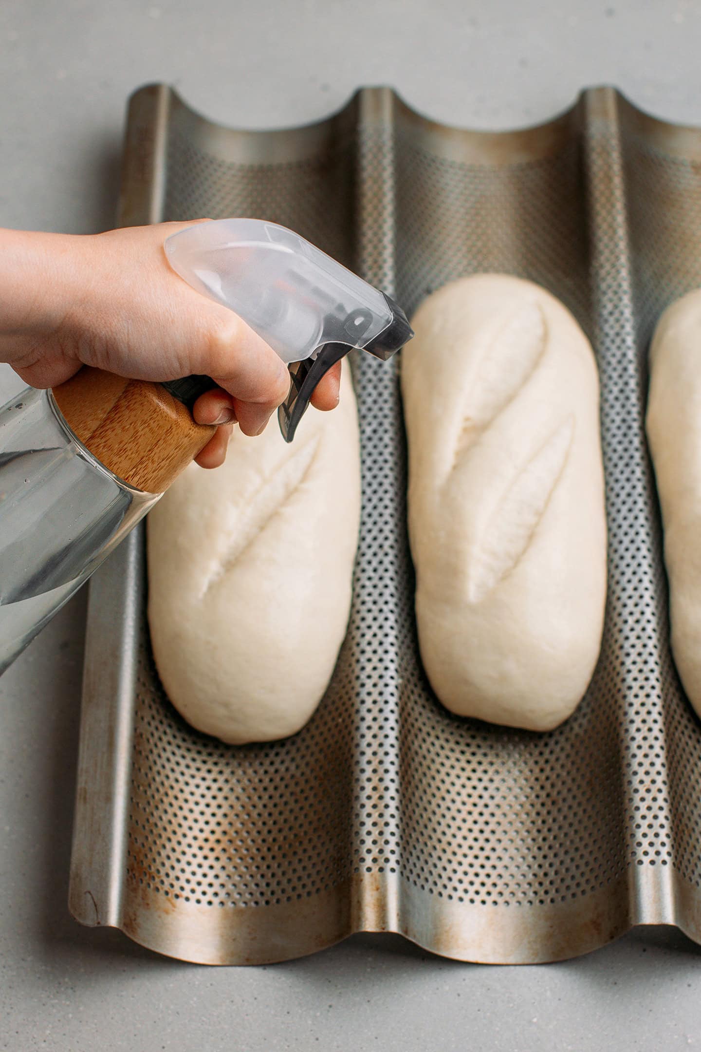 Spraying water on baguettes.
