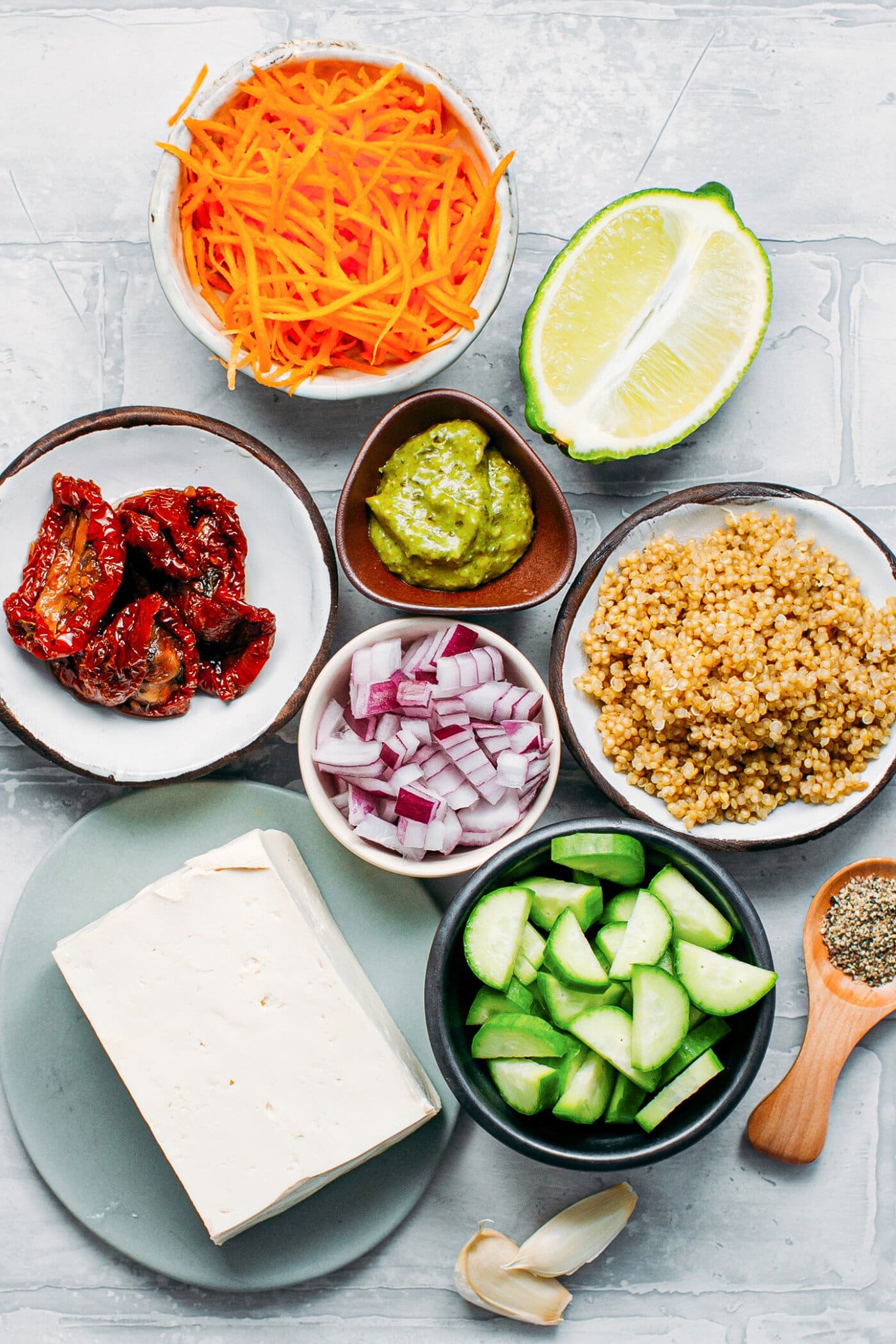 Ingredients to make a quinoa pesto salad with baked tofu.