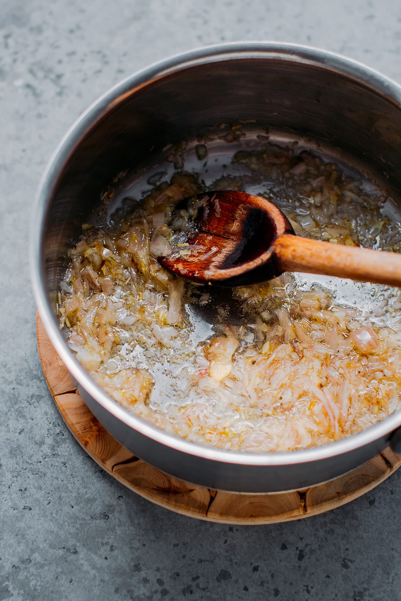 Frying shallots, ginger, and lemongrass.