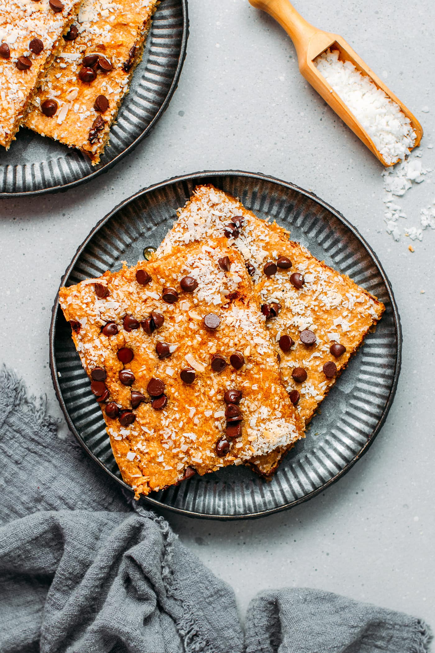 Sheet-pan coconut pancakes with chocolate chips on a plate.