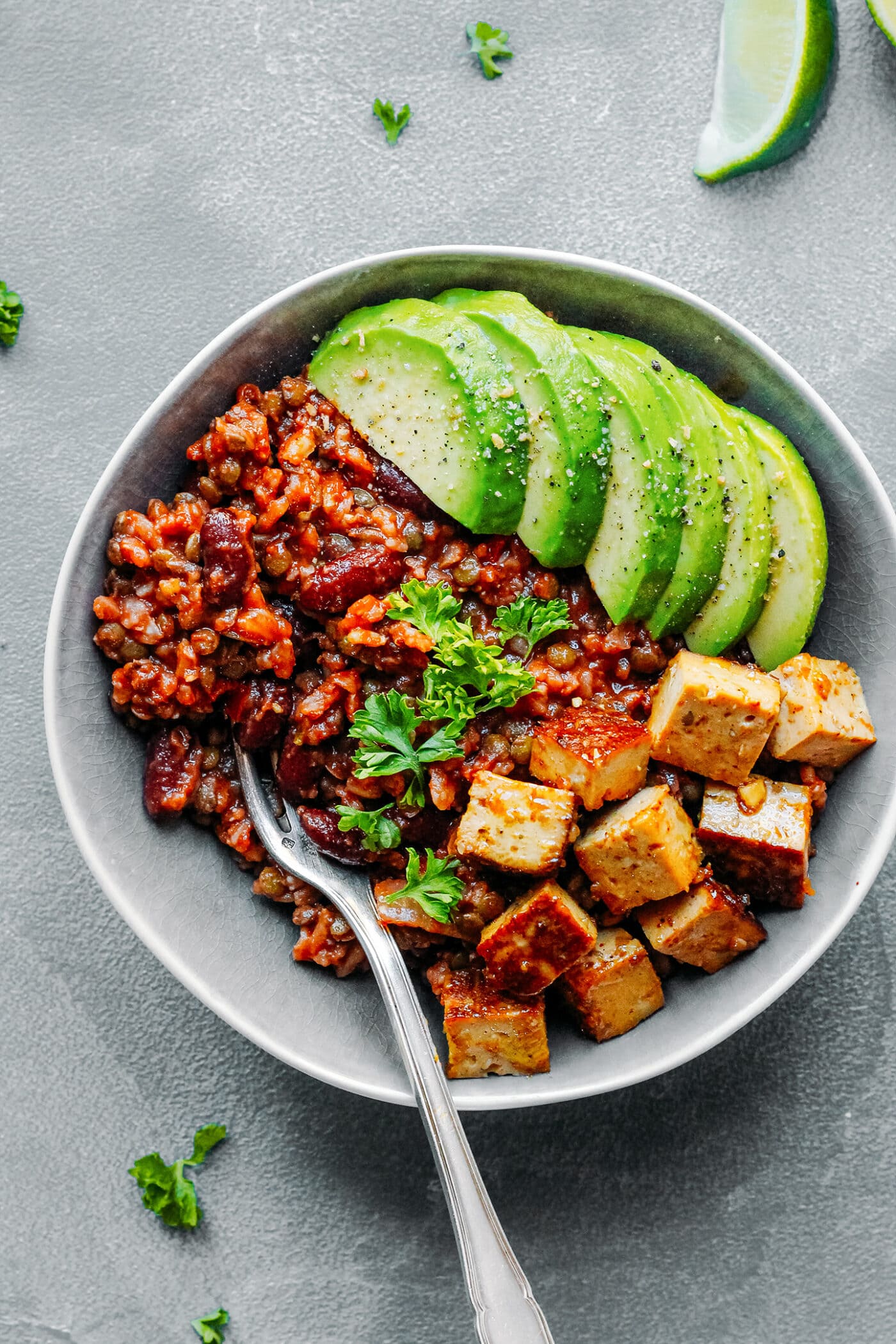 Enchilada rice and beans with sautéed tofu in a bowl.