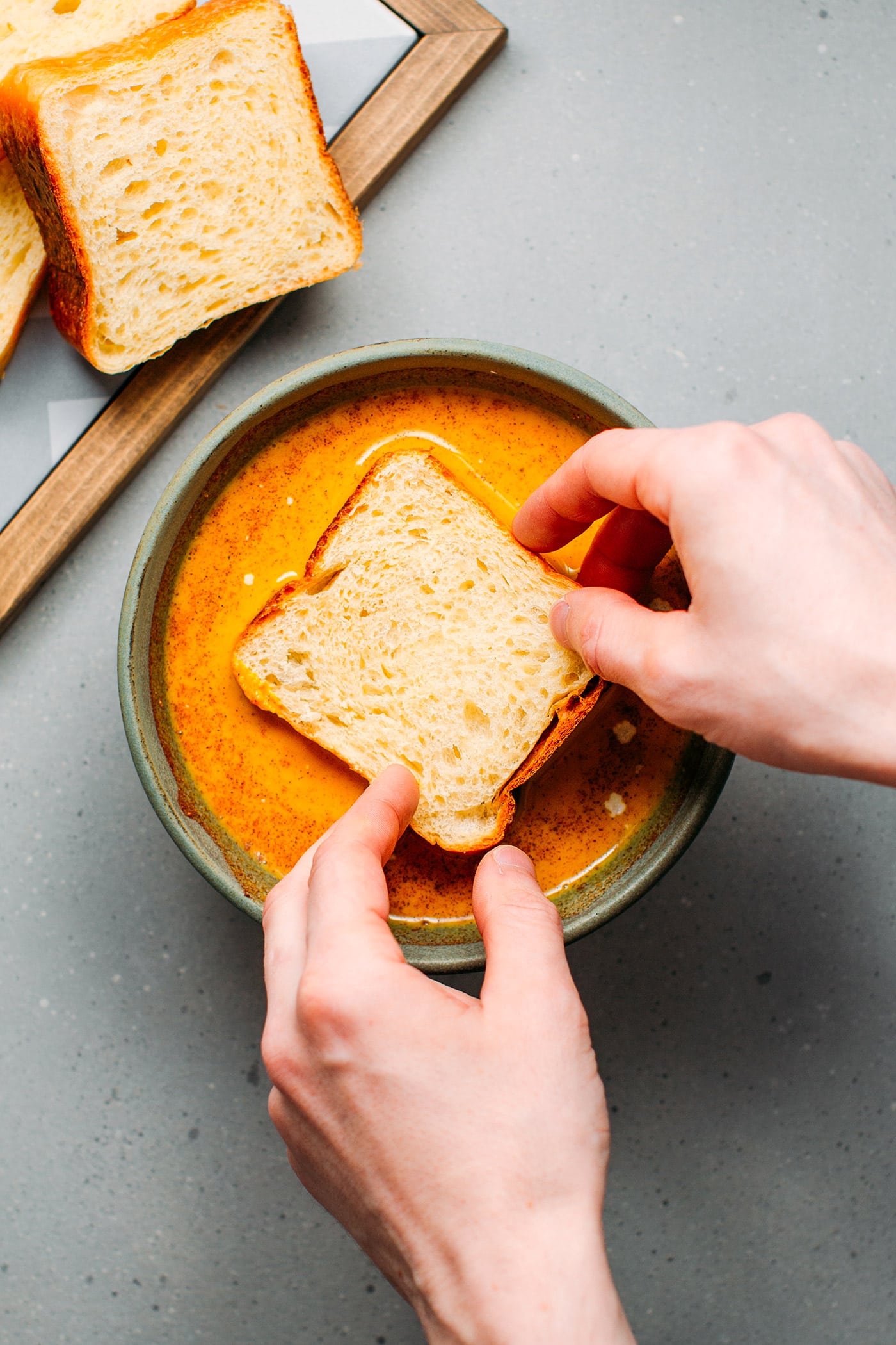 Dipping sandwich bread to make french toast