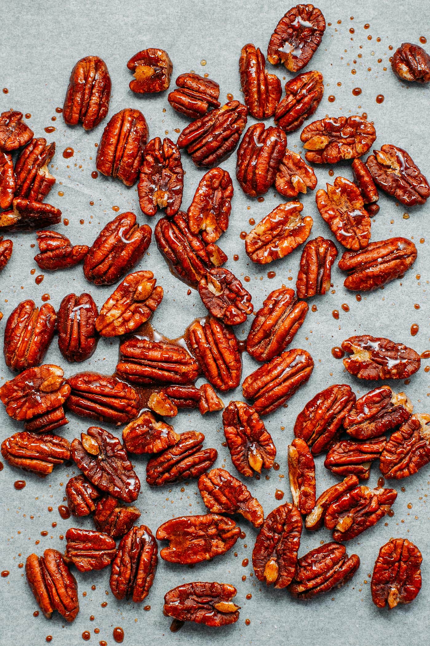 Caramelized pecans on a baking sheet