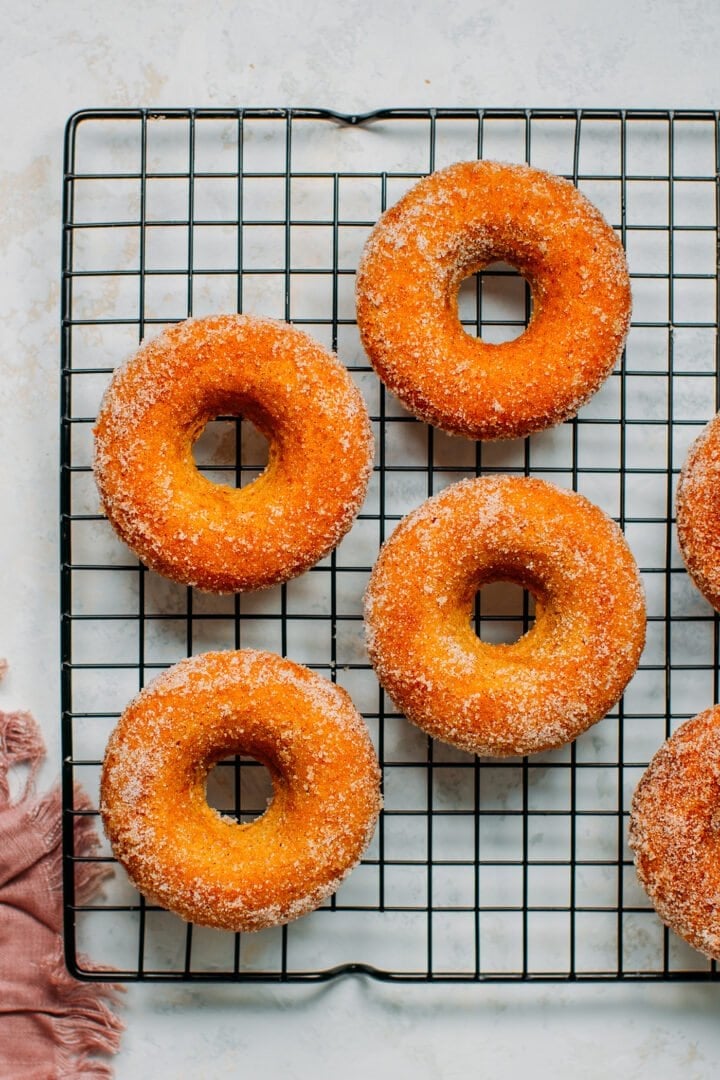 Vegan cinnamon sugar donuts on a cooling rack