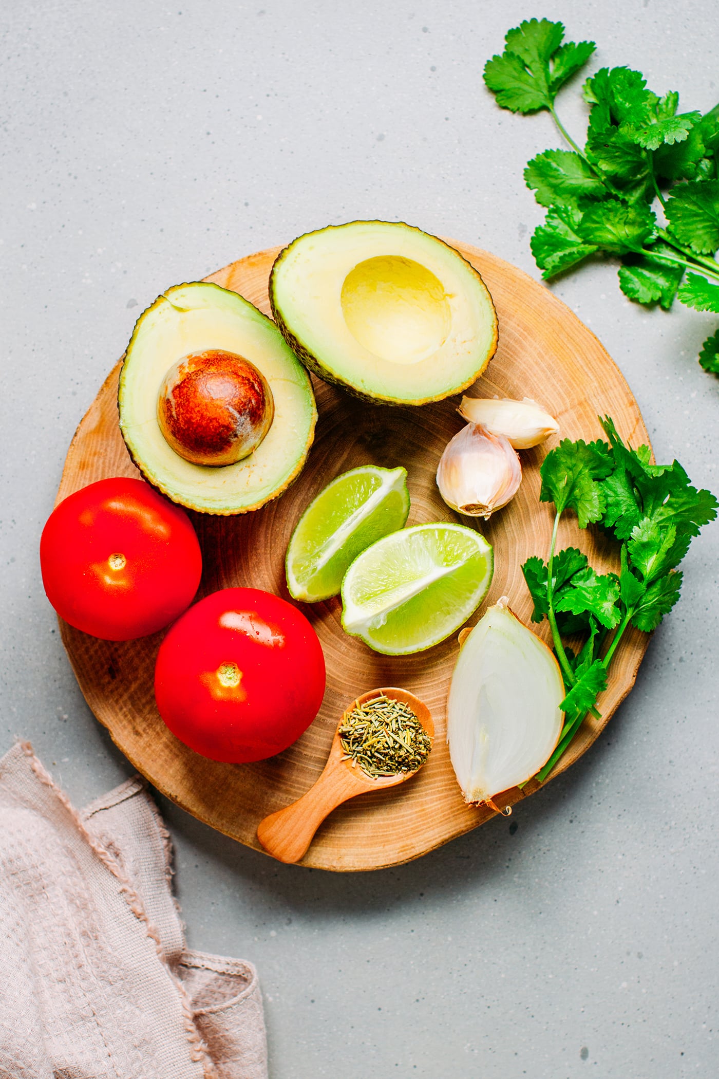 Ingredients like avocado, tomatoes, lime, onion, garlic, and cilantro.