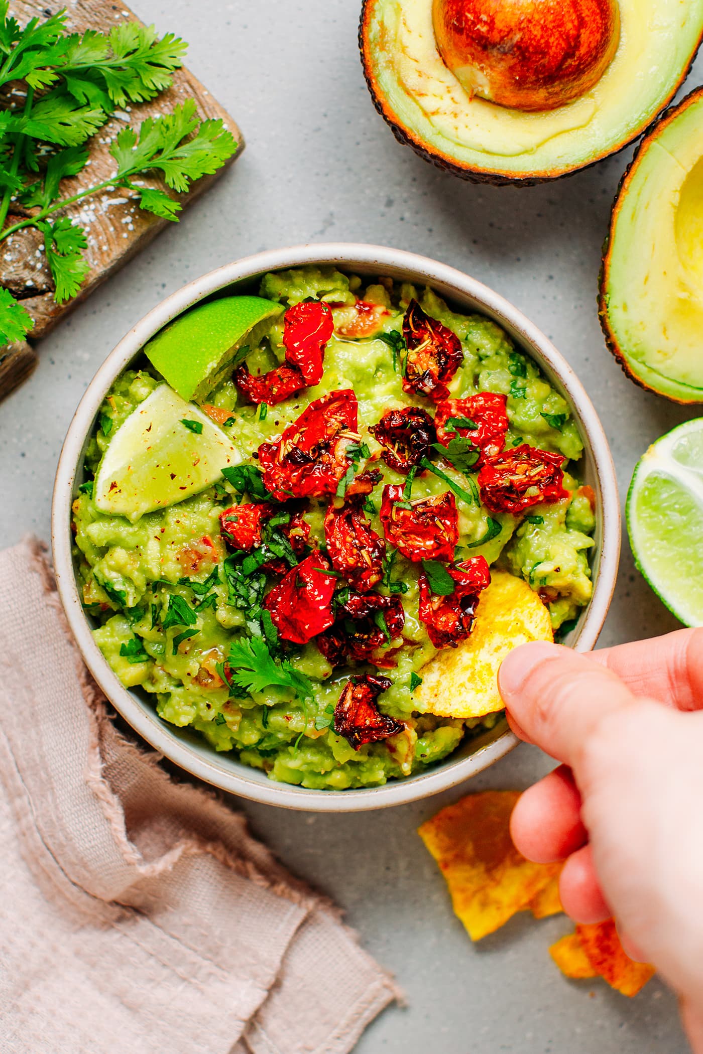 Dipping banana chips in guacamole.