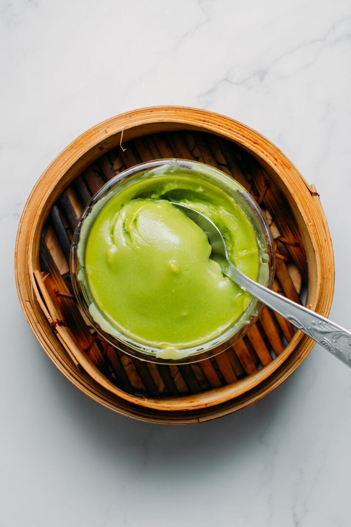 Matcha mochi dough in a bamboo steamer.