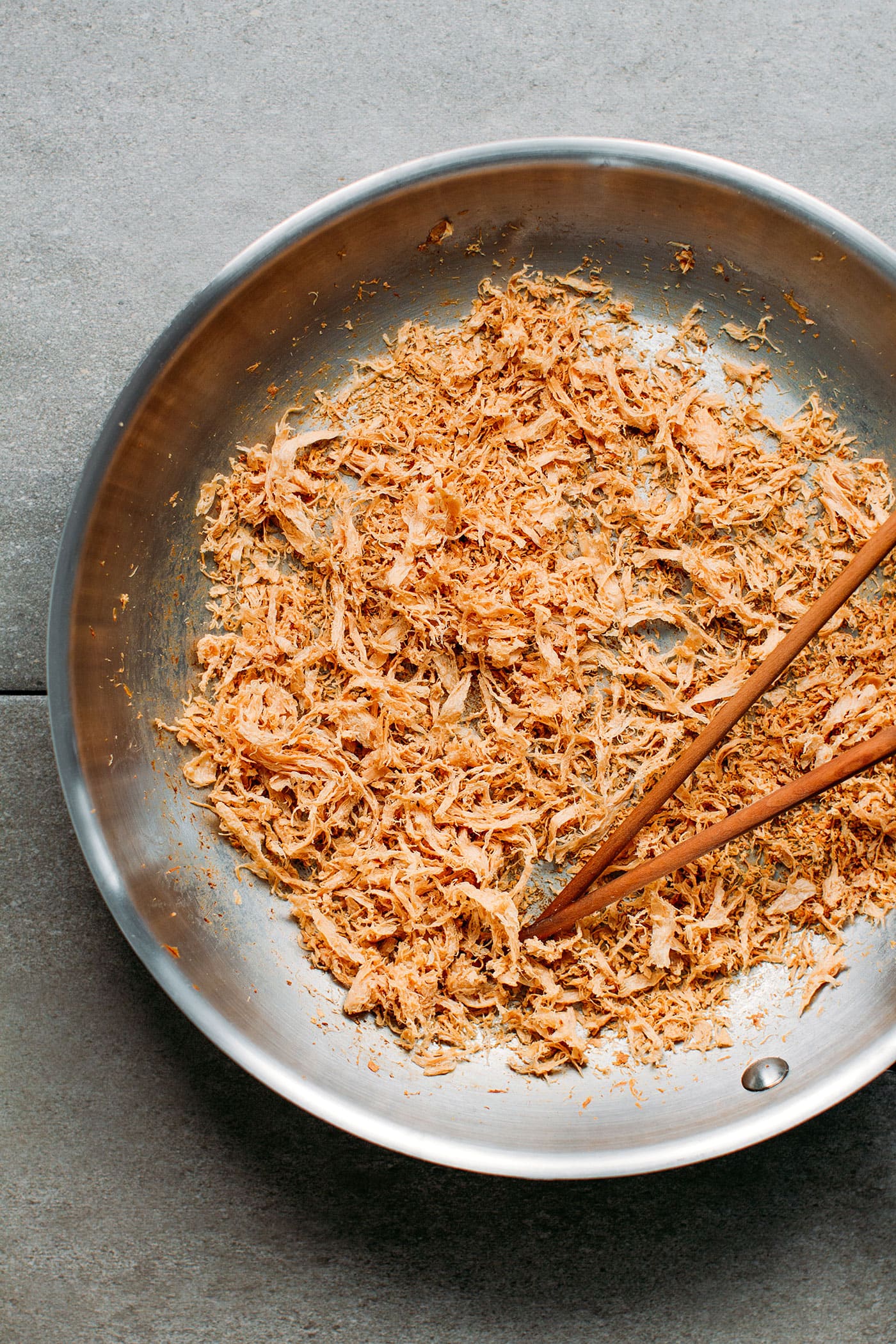 Drying meat floss in a skillet.