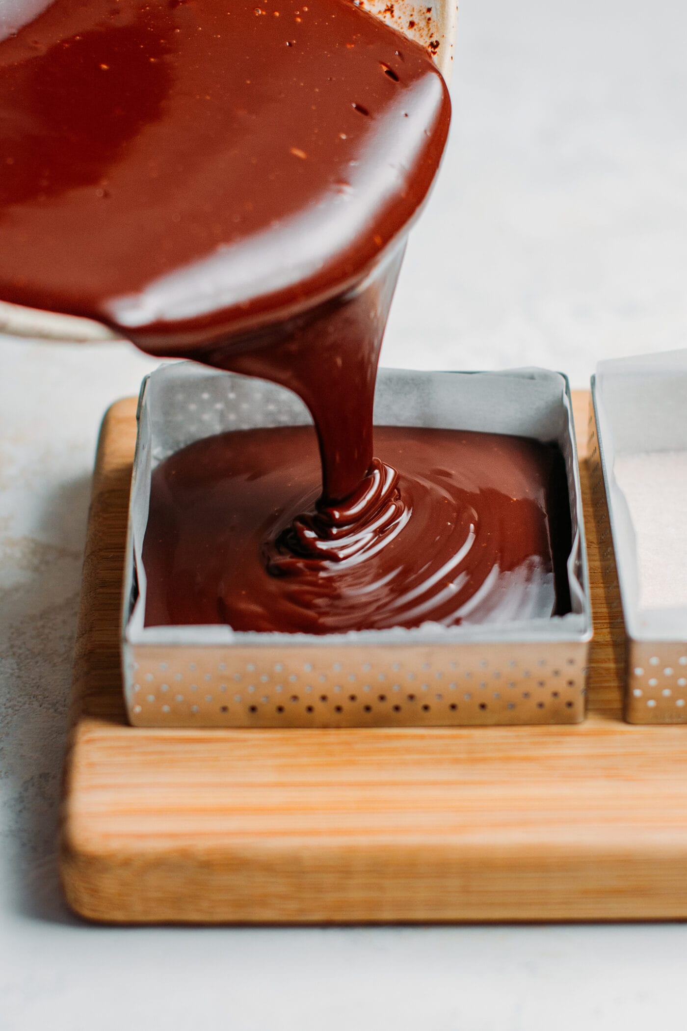 Pouring chocolate ganache into a mold.