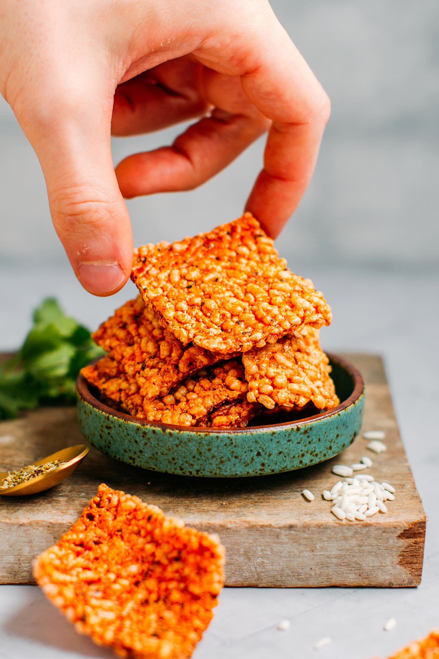 Picking a puffed rice cracker.