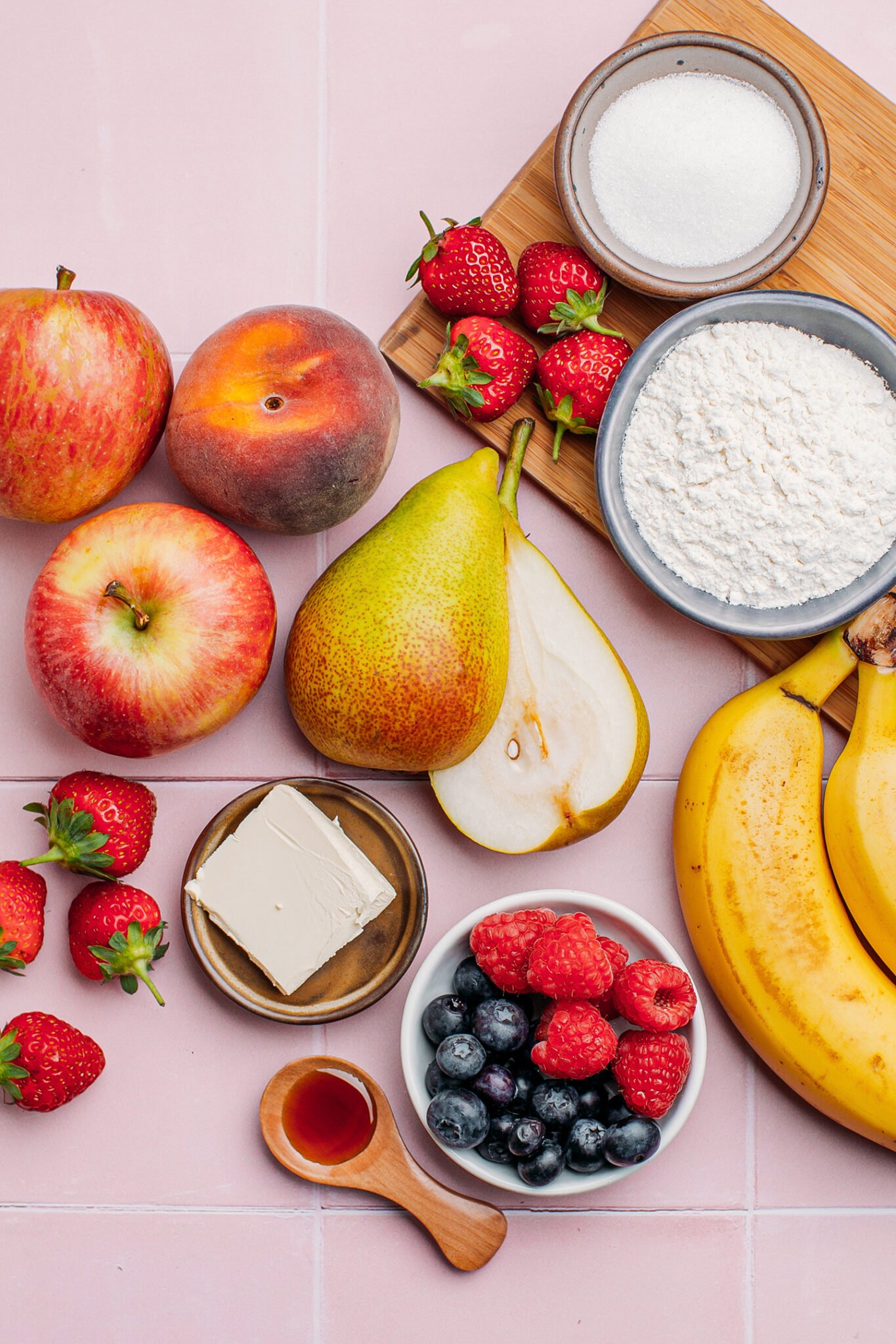 Fruits like bananas, pears, apples, peaches, and raspberries.