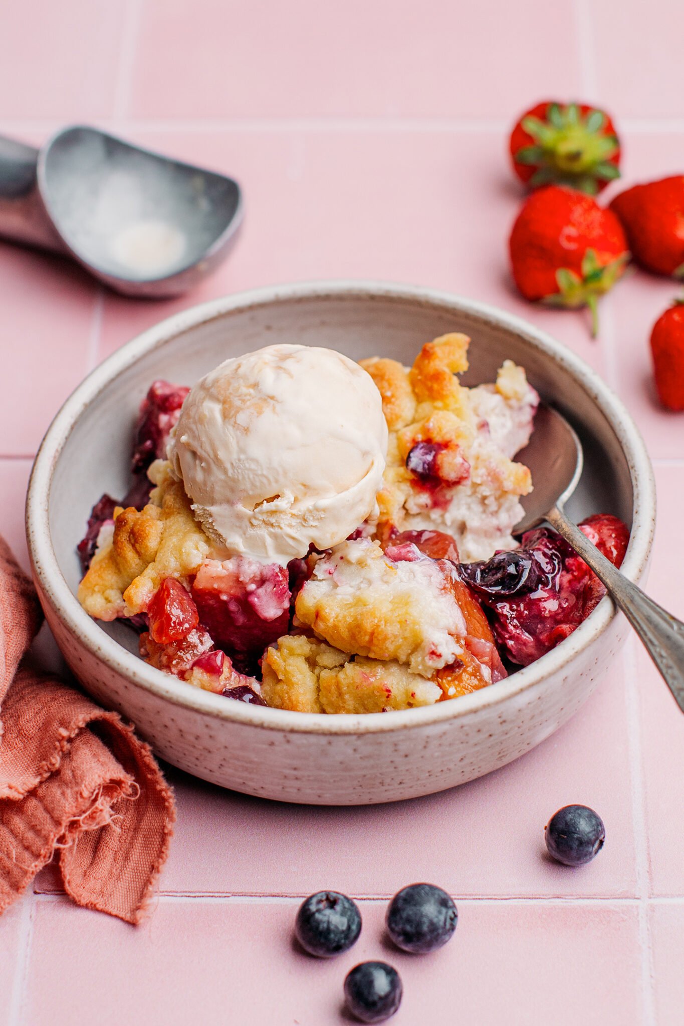 Fruit crumble in a bowl with mint leaves.