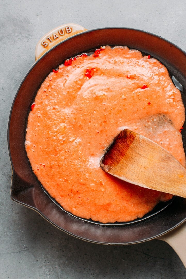 Cooking tomato sauce in a skillet.