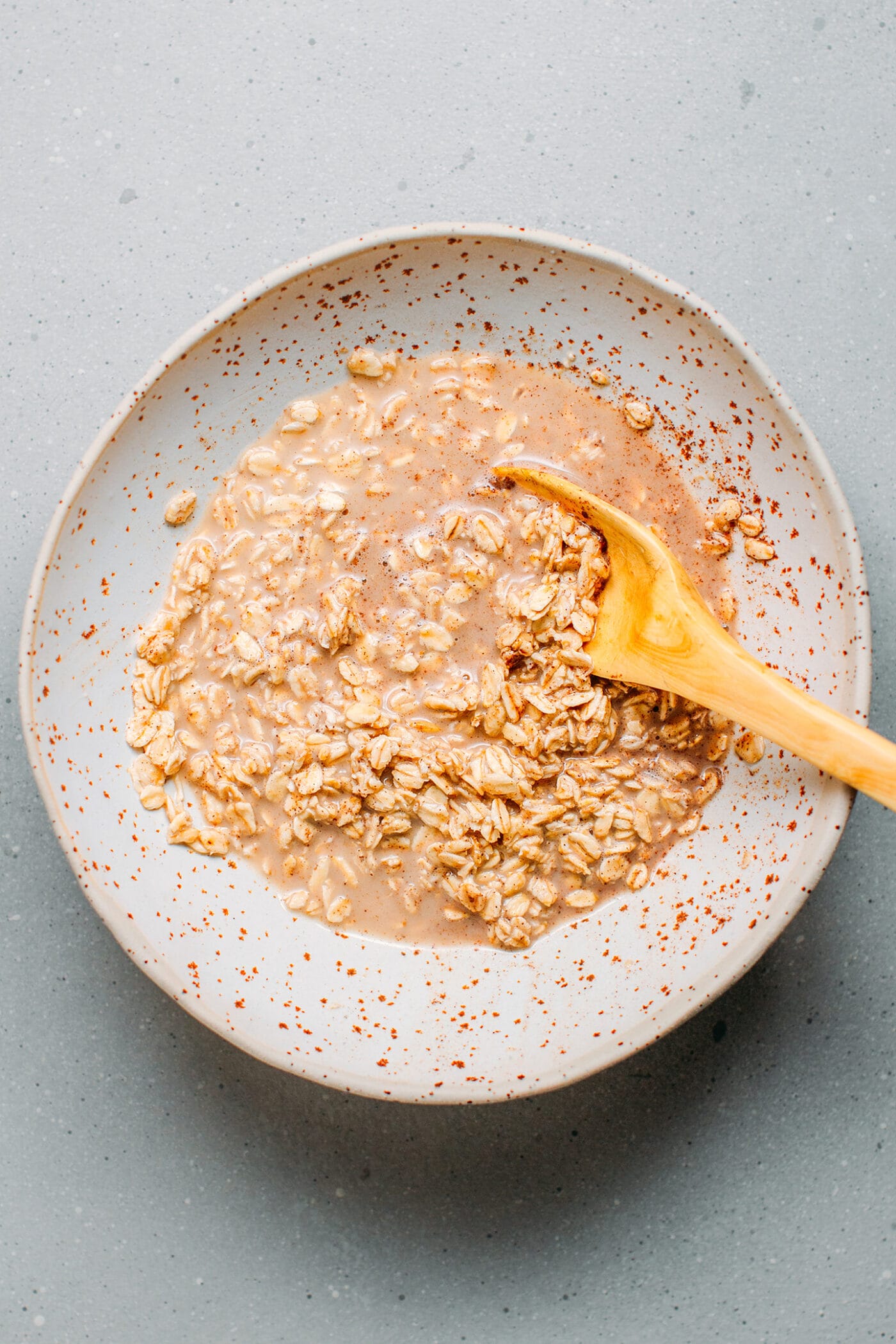 Whisking rolled oats to make overnight chai oats.