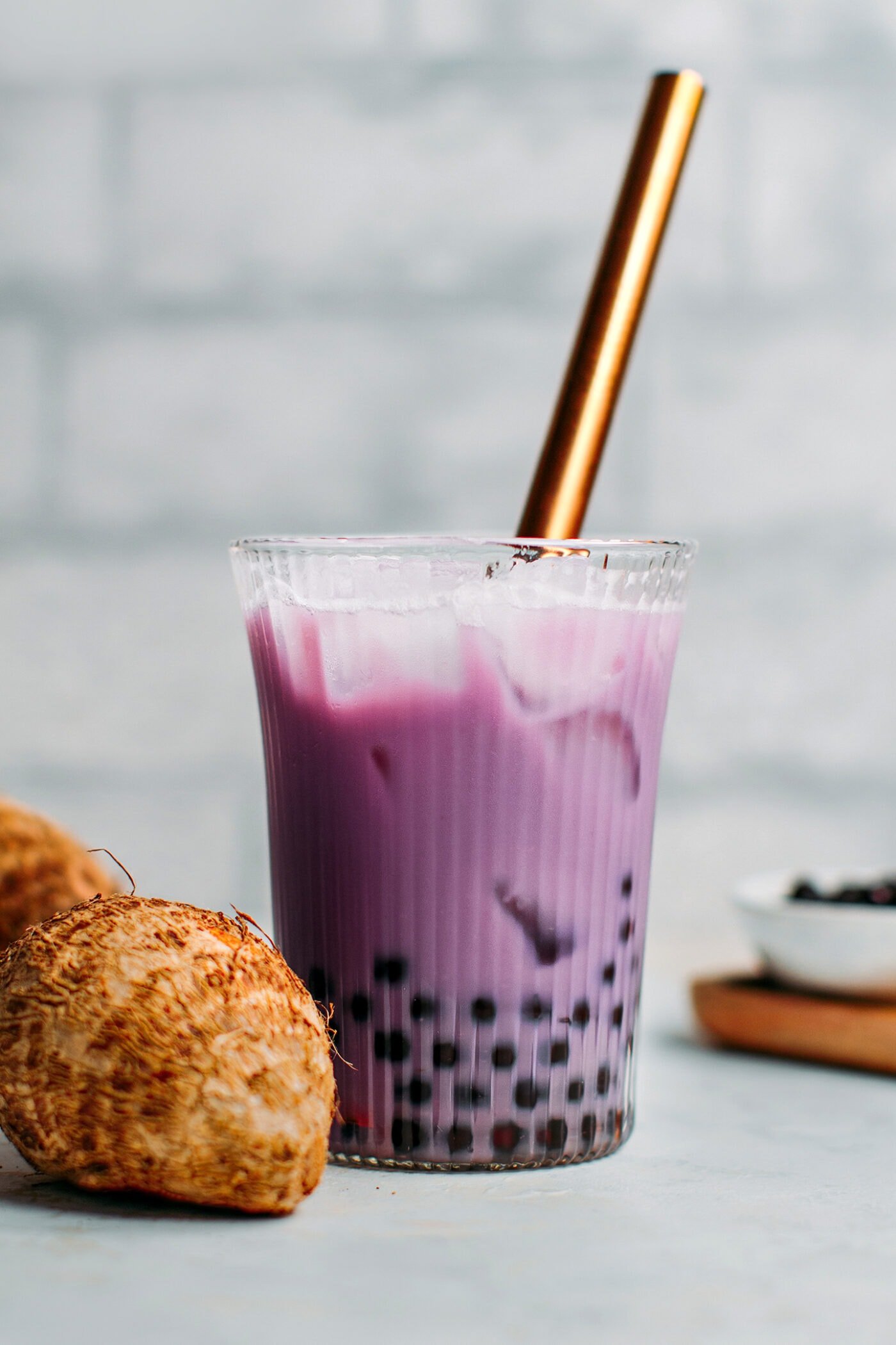 Vegan taro milk tea with tapioca pearls in a glass.