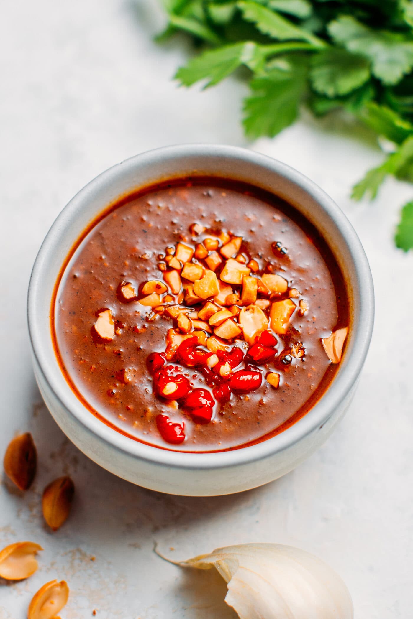 Hoisin peanut dipping sauce topped with peanuts and chili.