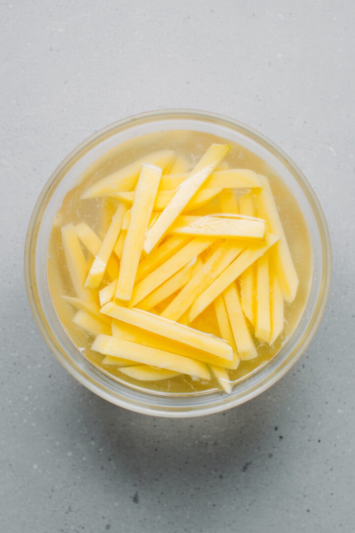 Potatoes soaking in cold water.