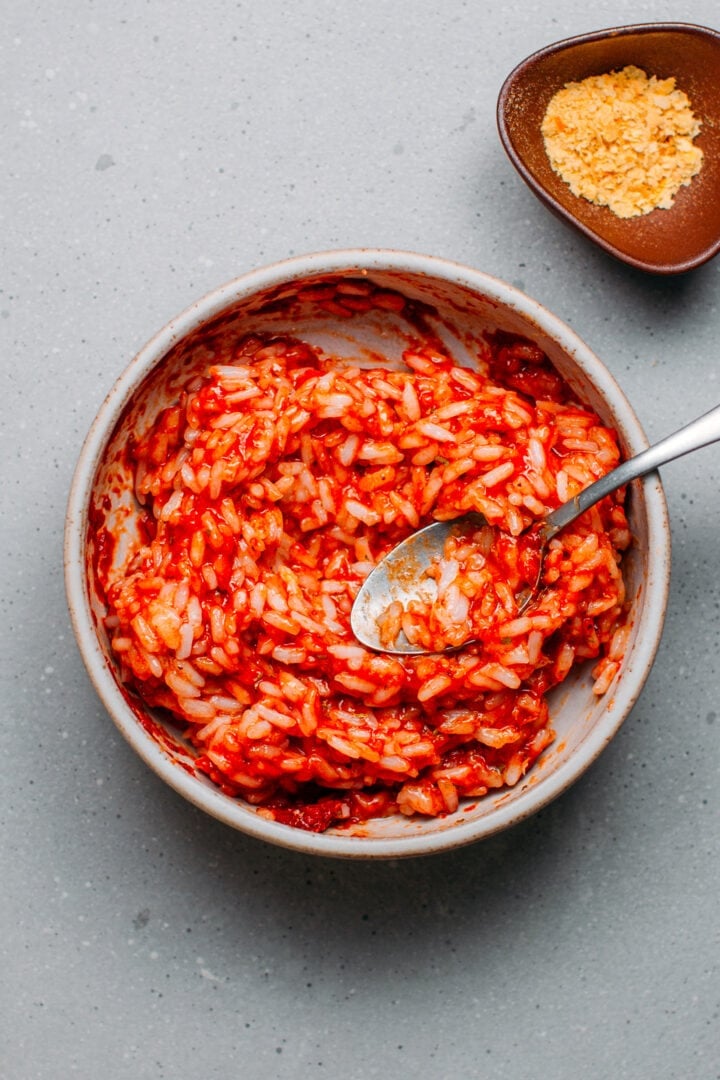 Rice coated with tomato paste and herbs.